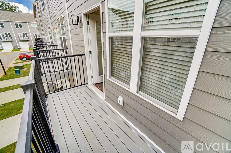 A balcony with a sliding door and a window with blinds.