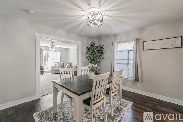 A dining room with a table and chairs.