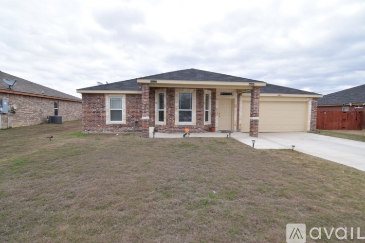 A house with a brown roof and a white garage door is shown.