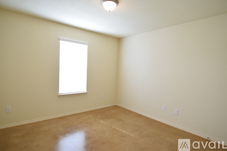 A room with a window and a light on the ceiling.