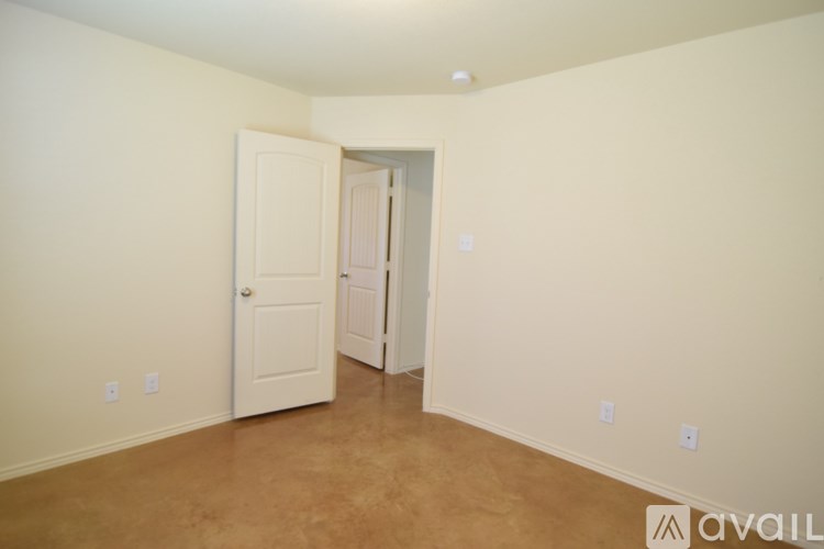 A room with a white door and a white wall.