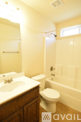 A bathroom with a toilet, sink, and bathtub.