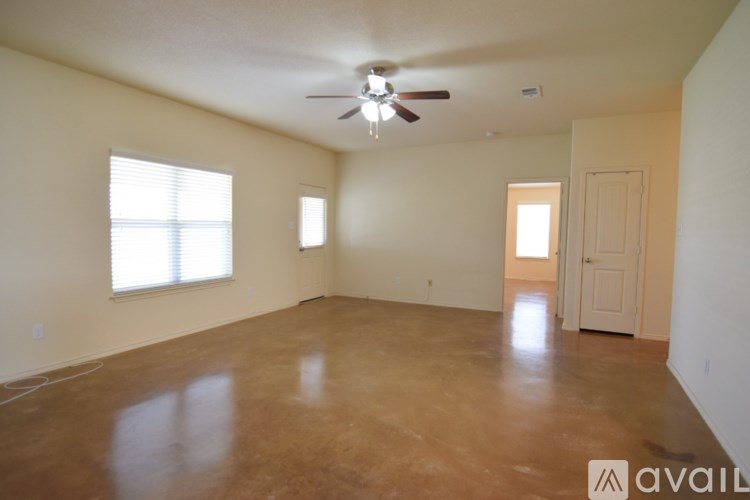 A room with a ceiling fan and a window.