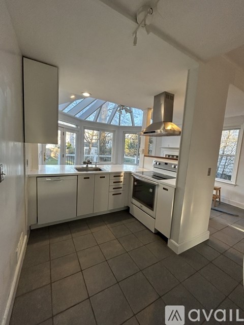 A kitchen with a stove top oven and a range hood.