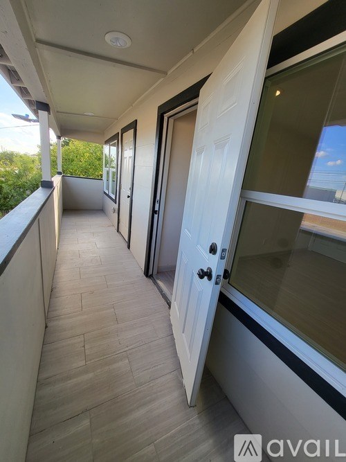 A balcony with a door and a window.