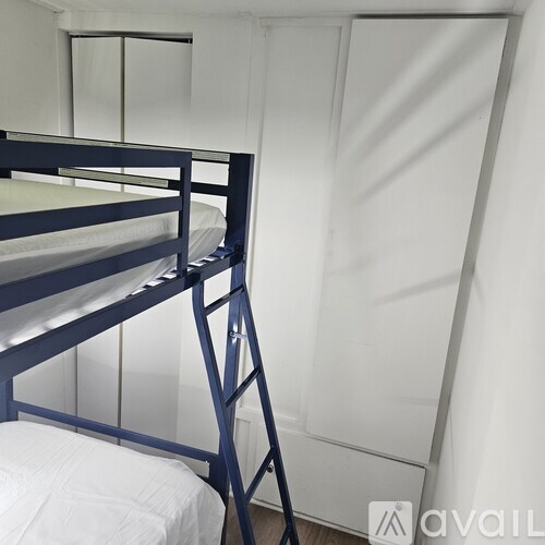 A bunk bed with a ladder in a room.