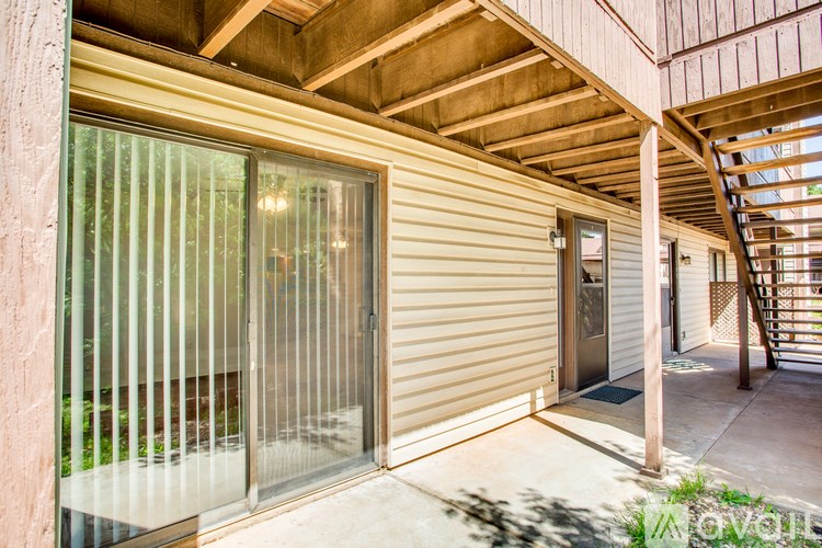 A modern house with a glass door and a wooden ceiling.
