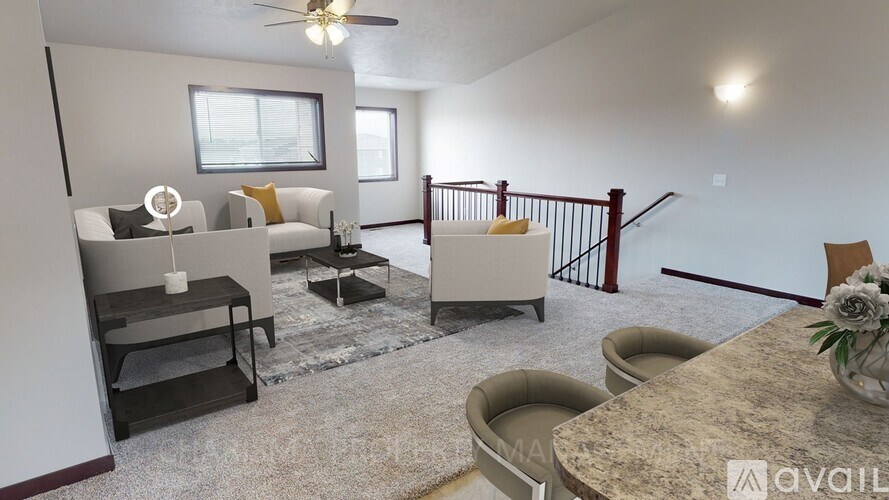 A living room with a sofa, chairs, and a table.