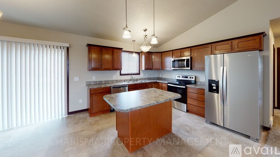 A kitchen with wooden cabinets and a granite countertop.