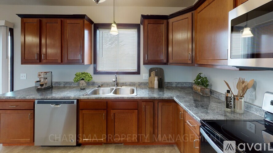 A kitchen with wooden cabinets and a black stove top oven.