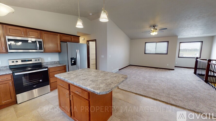A kitchen with wooden cabinets and a granite countertop.