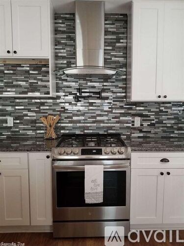 A kitchen with a stove and cabinets.