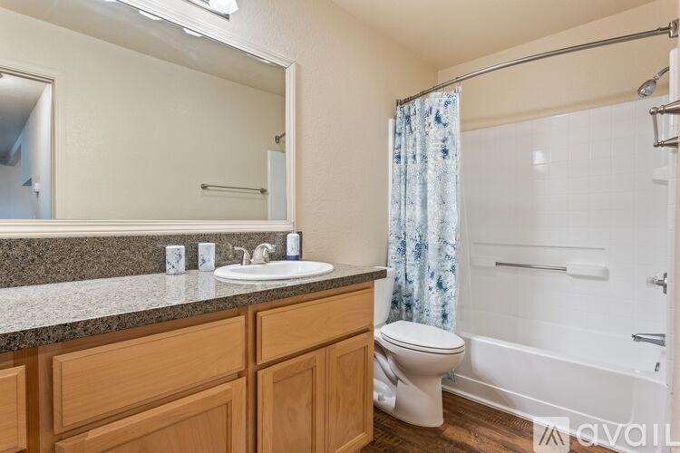 A bathroom with a sink, toilet, and bathtub.