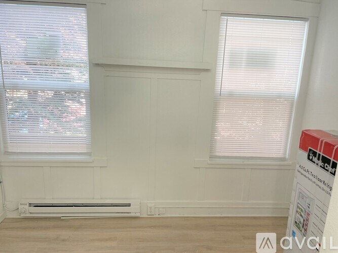 A room with a window and a sign that says "Available".