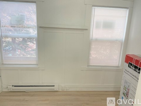 A room with a window and a sign that says "Available".