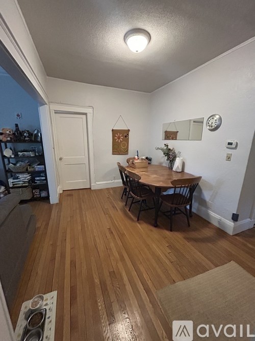 A dining room with a wooden table and chairs.