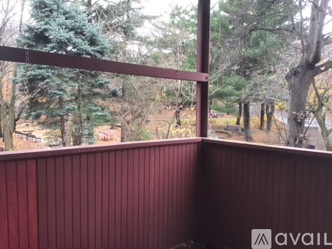 A red building with a view of trees in the background.