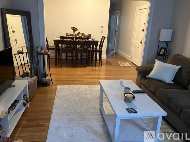 A living room with a white coffee table and a grey couch.