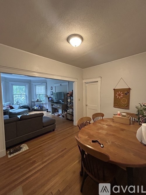 A dining room with a wooden table and chairs.