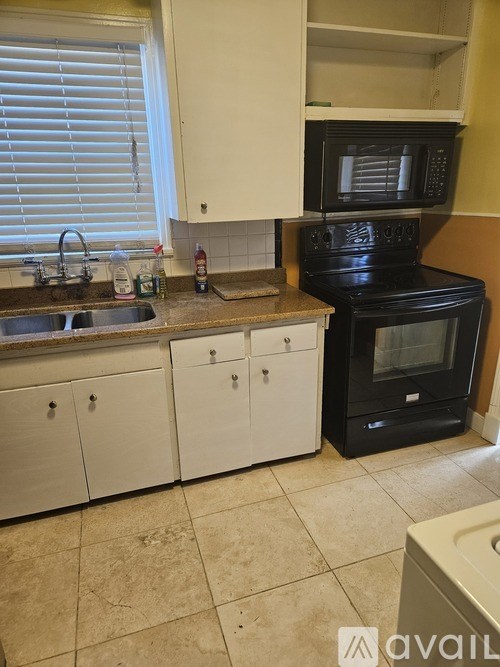 A black microwave oven is on the counter.