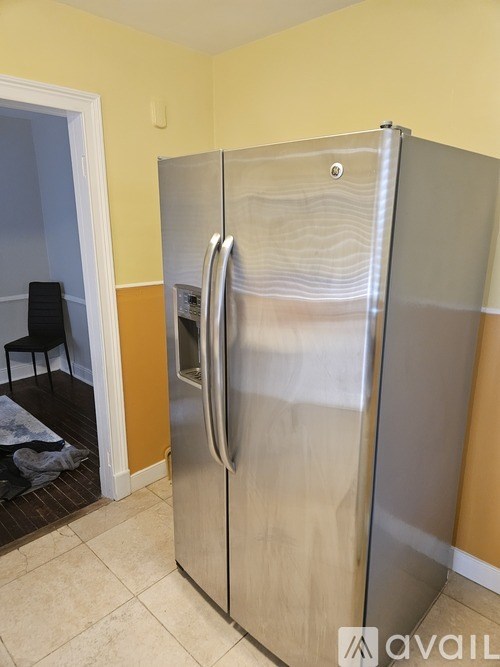 A stainless steel refrigerator in a kitchen.