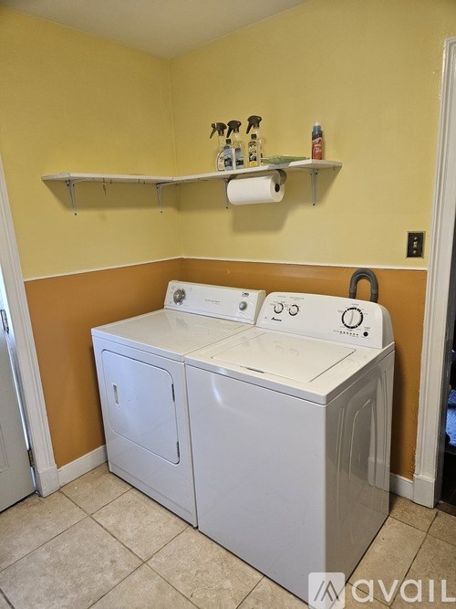 A white washer and dryer in a small laundry room.