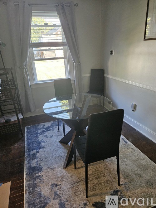 A room with a table and chairs in it.