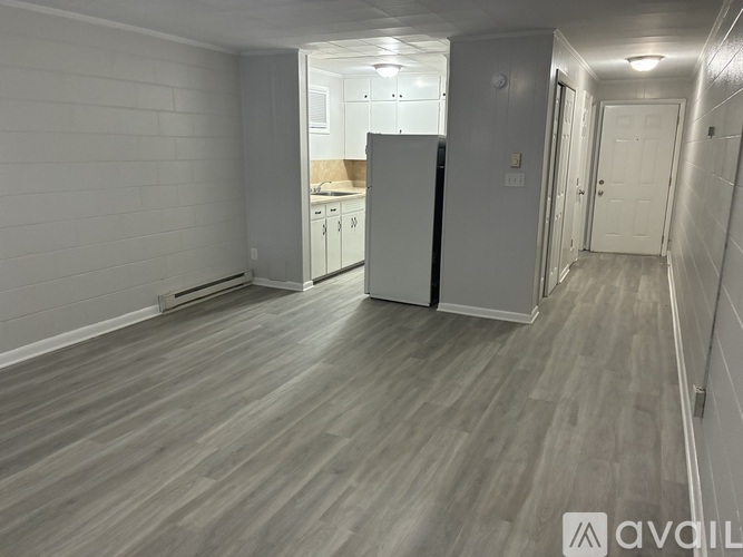 A kitchen with white cabinets and a stove top oven.