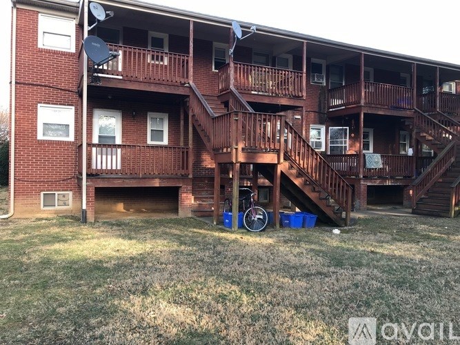 Apartment complex with a bicycle and two buckets.