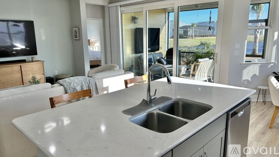 A kitchen with a marble countertop and a sink.