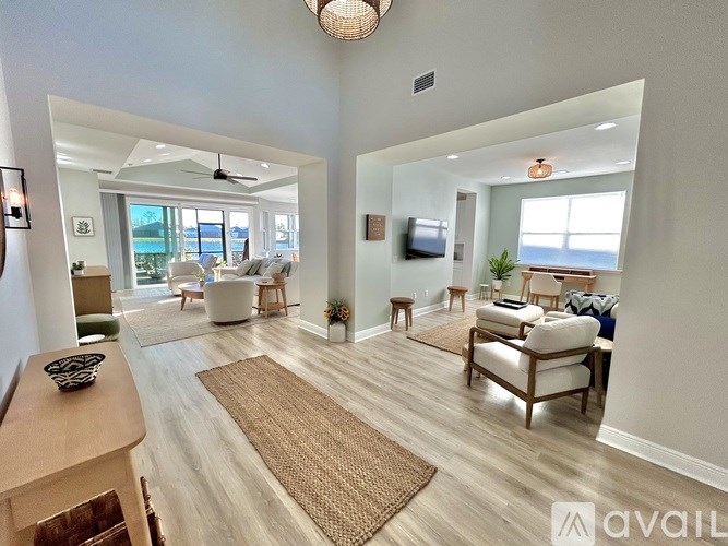 A living room with a television, a couch, and a chair.