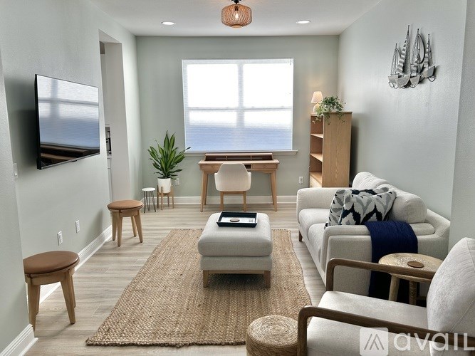 A living room with a couch, chair, and a rug.