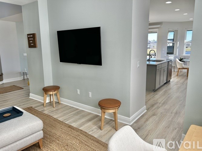 A living room with a flat screen TV mounted on the wall.