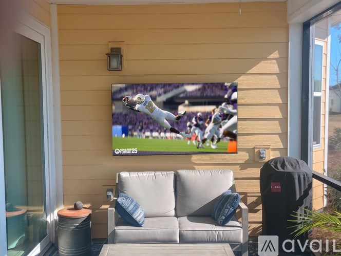 A flat screen TV mounted on a wall displaying a sports game.
