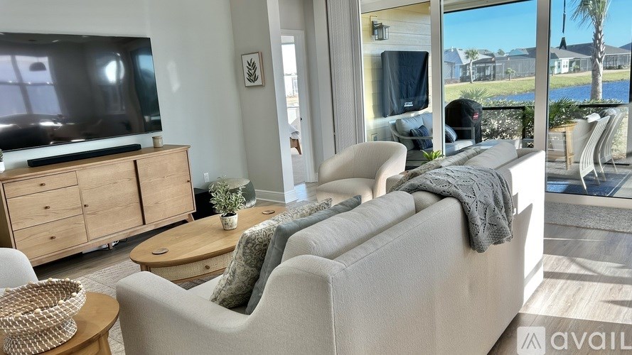 A living room with a grey couch and a wooden cabinet.