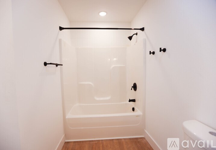 A white bathroom with a walk in shower.