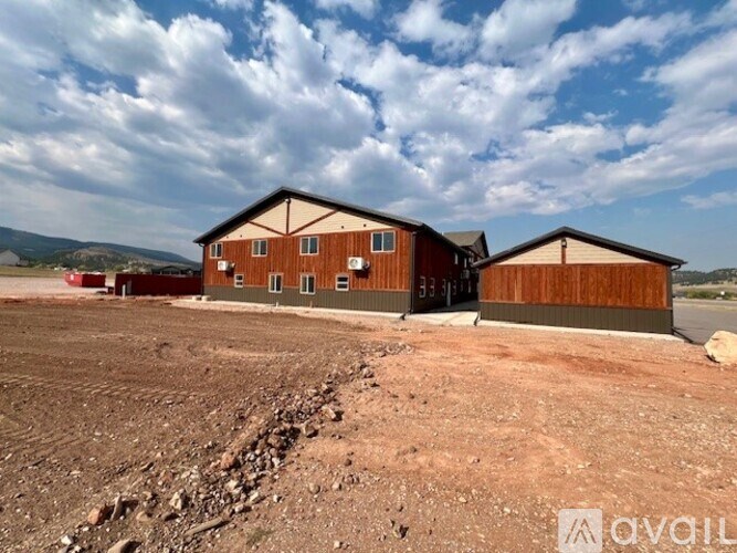 A large building with a brown facade is situated in a barren landscape.