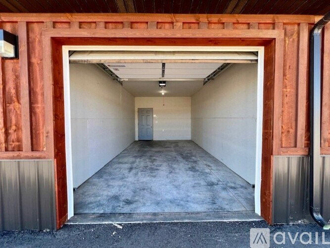 A large open garage door with a red frame.