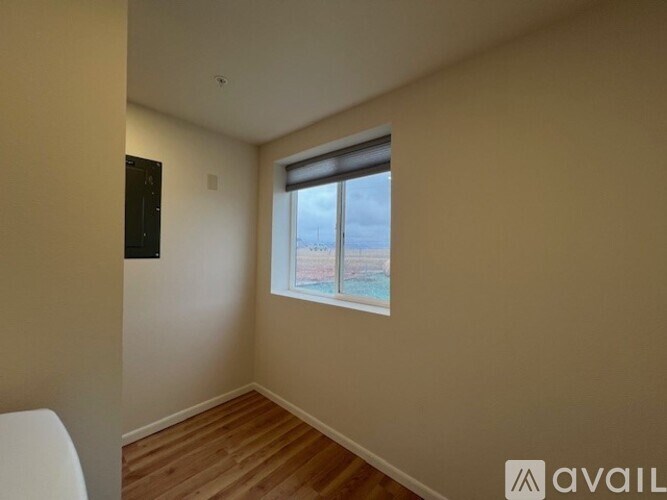 A room with a window overlooking a beach.