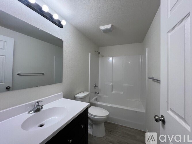 A bathroom with a sink, toilet, and bathtub.