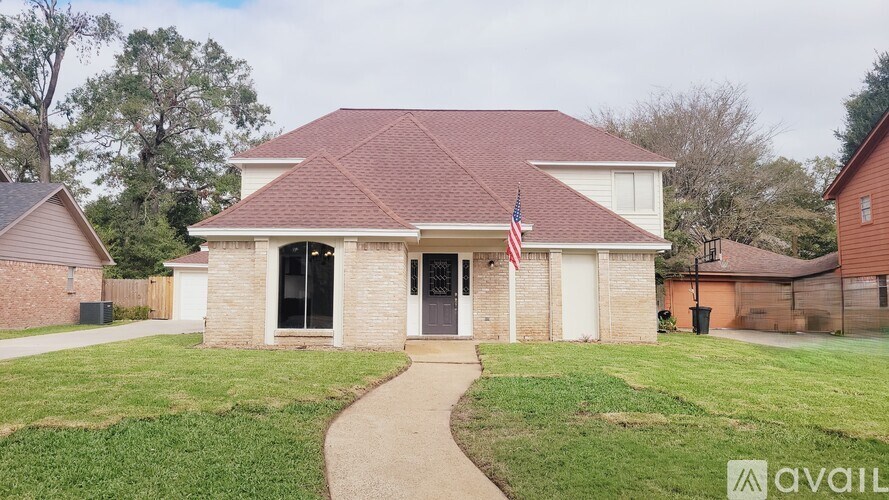 A house with a flag on the front porch is for sale.