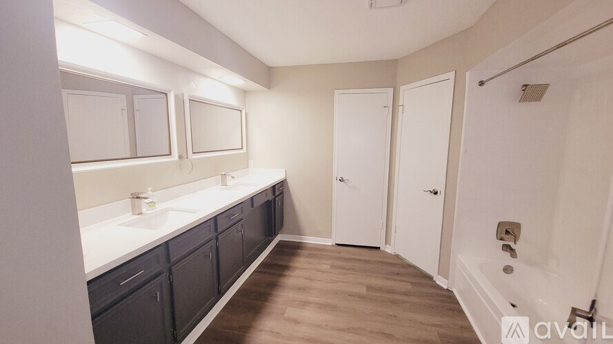 A bathroom with a vanity and a shower.