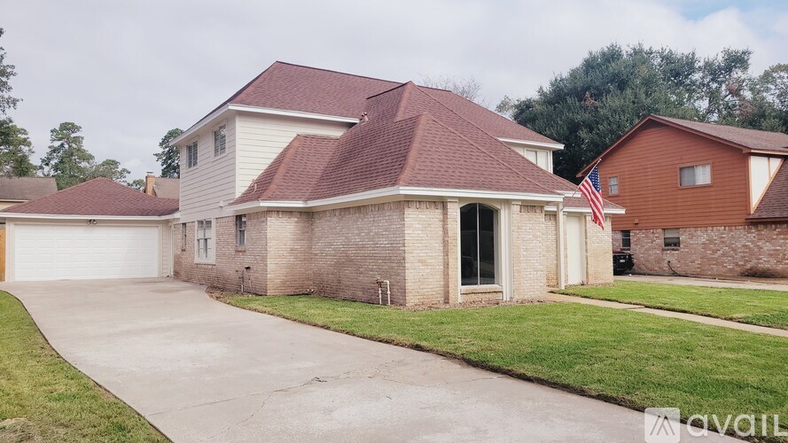 A house with a flag on the front lawn.