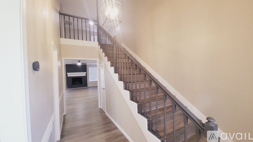 A staircase with a light on the wall.