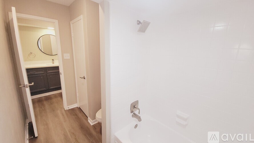 A bathroom with a toilet, sink, and mirror.