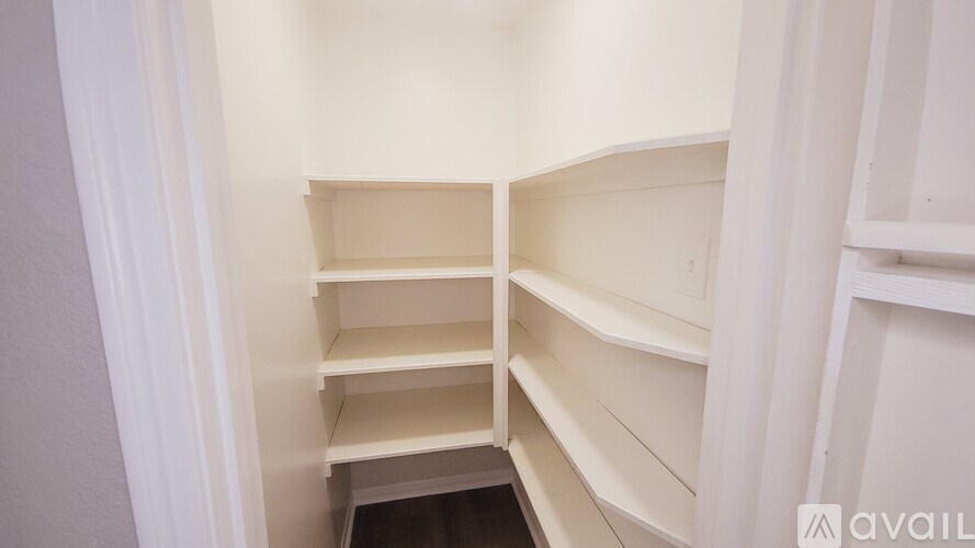 Empty white shelves in a room.