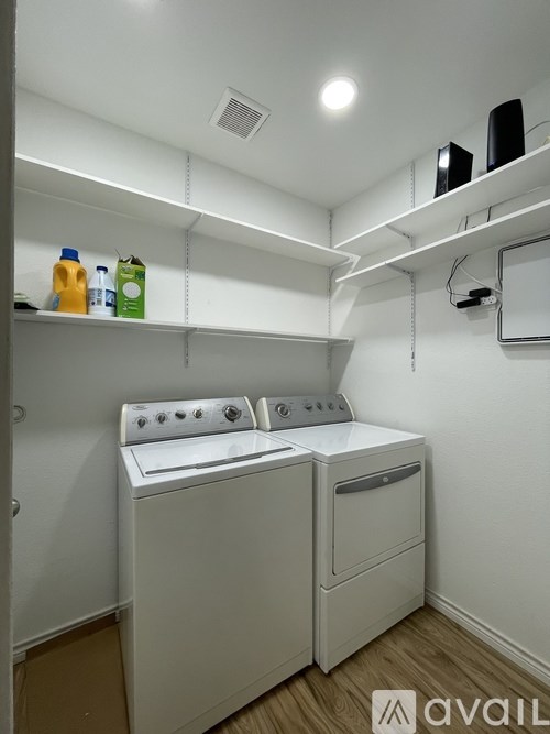 A small laundry room with a washer and dryer.