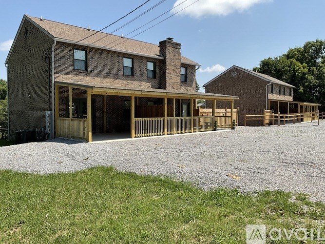 A house with a brown roof and a wooden deck.