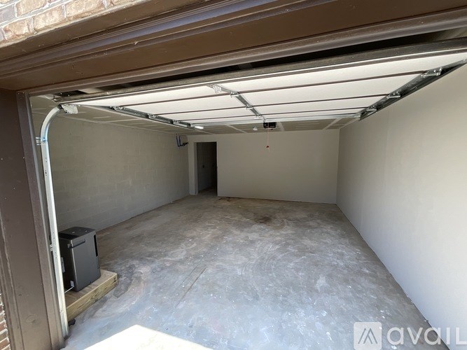 A spacious garage with a concrete floor and a white ceiling.