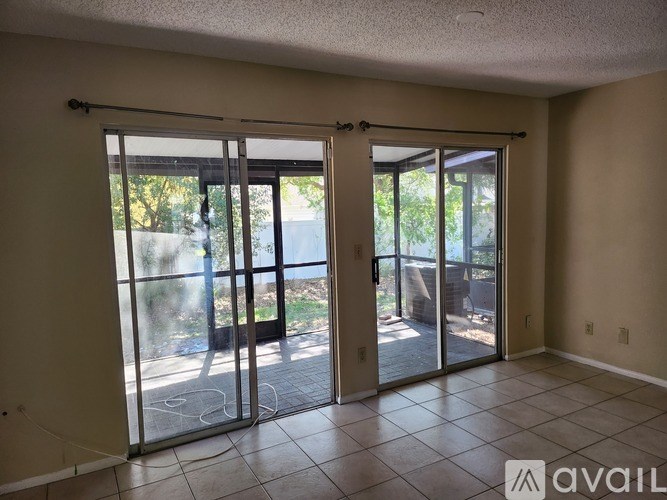A room with a sliding glass door leading to a backyard.